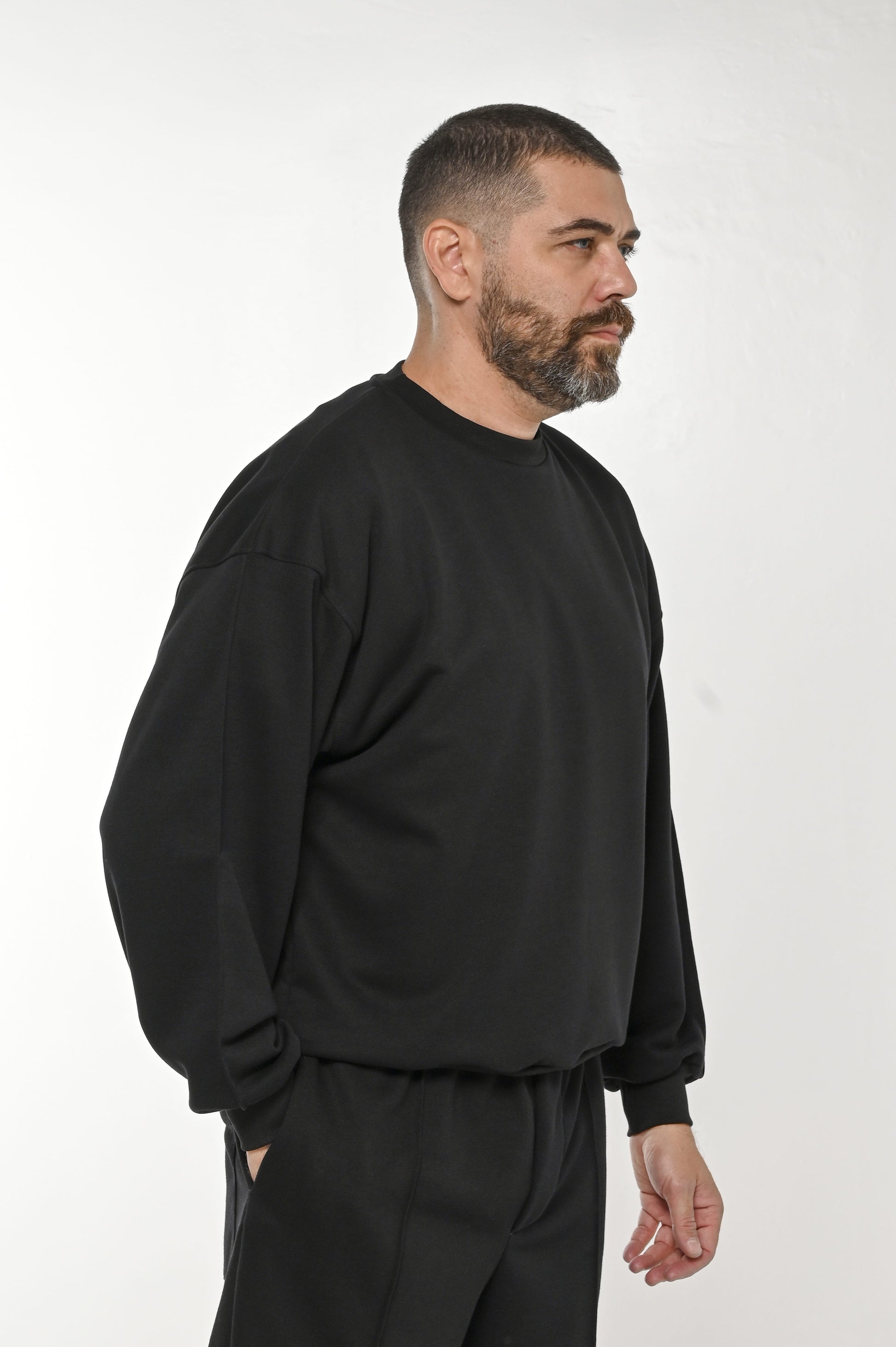 Gente Guapa black hoodie with “11:11 Everything will come to you at the perfect time” print — unisex streetwear side view