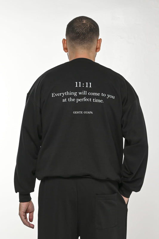 Gente Guapa black hoodie with “11:11 Everything will come to you at the perfect time” print — unisex streetwear back view