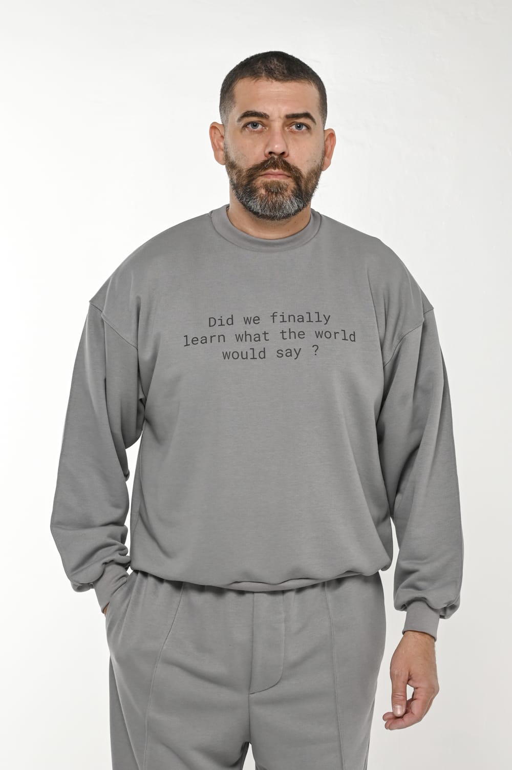 Gente Guapa black hoodie with “Did we finally learned what world would say” quote — unisex streetwear front view