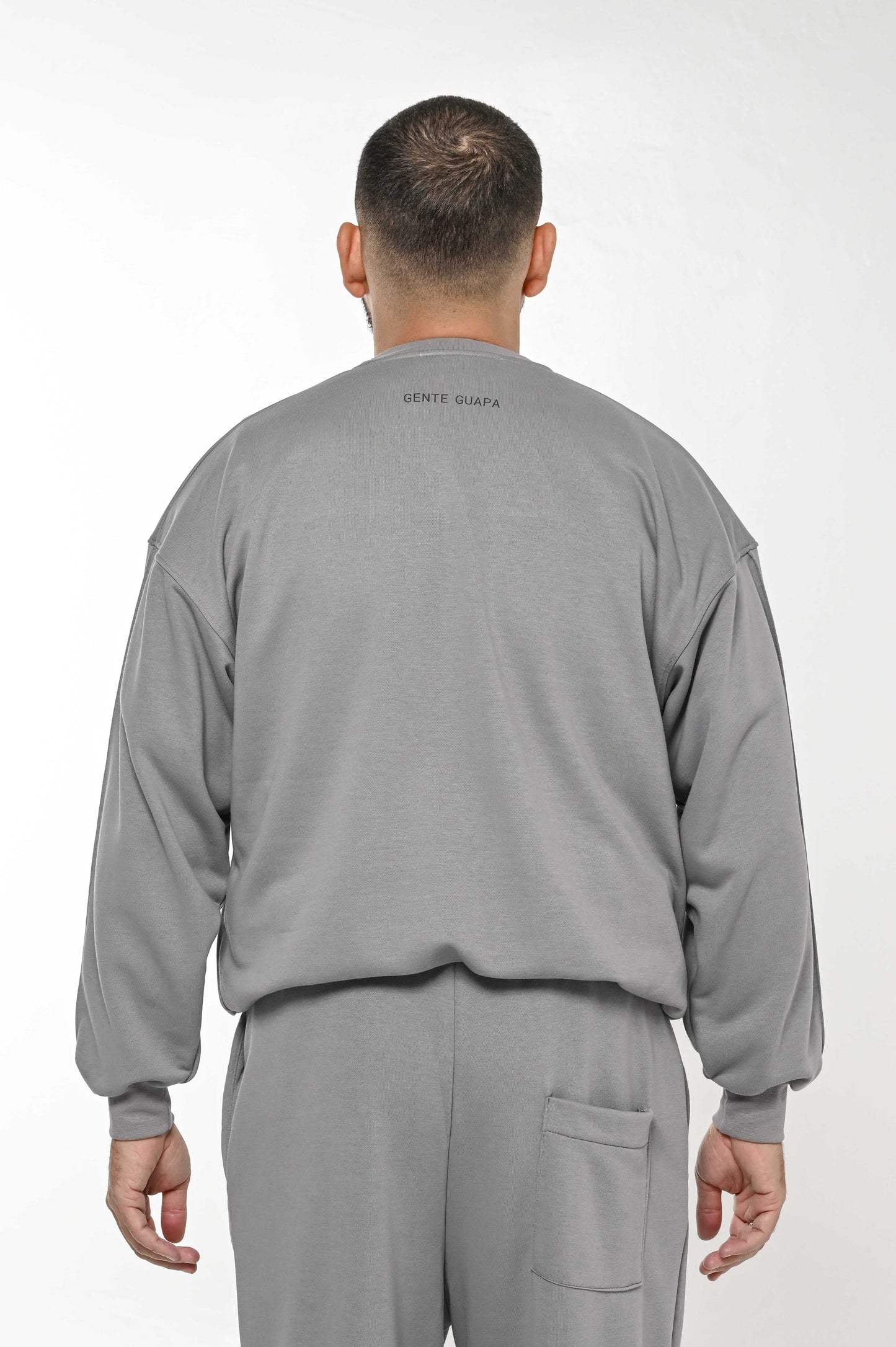 Gente Guapa black hoodie with “Did we finally learned what world would say” quote — unisex streetwear back view