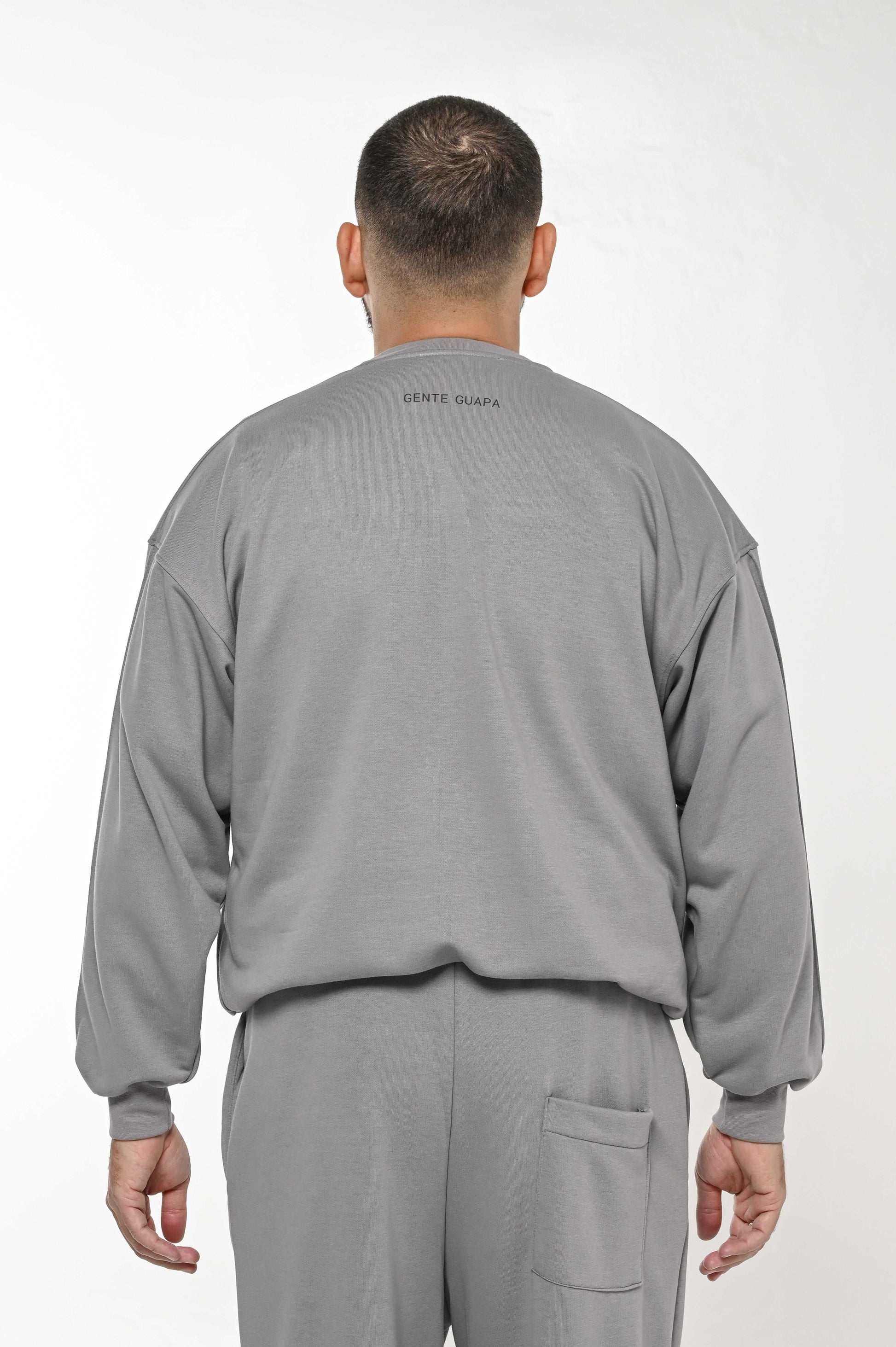 Gente Guapa black hoodie with “Did we finally learned what world would say” quote — unisex streetwear back view